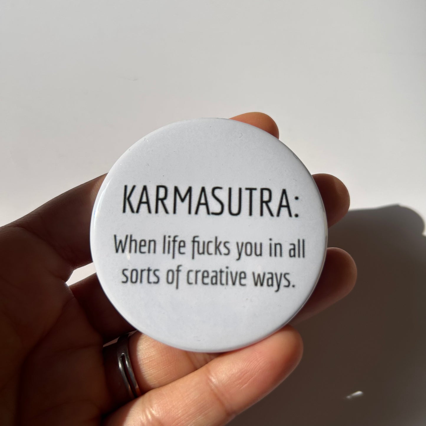 Karmasutra Badge